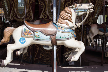 Fototapeta na wymiar merry-go-round wooden horses. ride a carousel