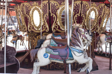 Fototapeta na wymiar merry-go-round wooden horses. ride a carousel