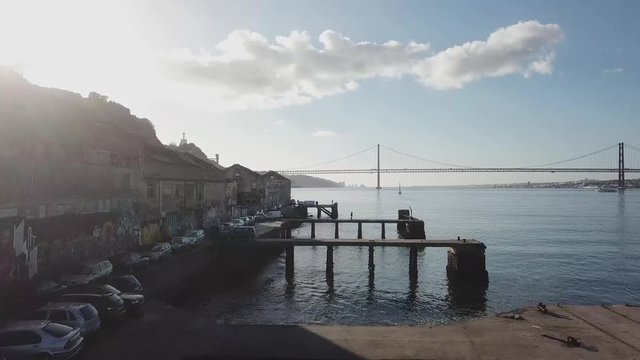 Birdview of Almada old docks with lisbon bridge over Tejo river landscape