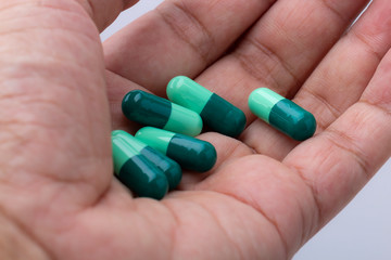 Closeup of medicine on hand.