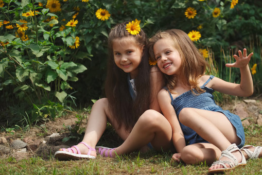 portrait of happy beautiful girls in flowerbed