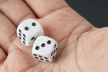 a dice on a palm of the hand