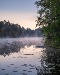 Obraz na płótnie Canvas Beautiful landscape with lake fog and sunrise at autumn morning in Finland