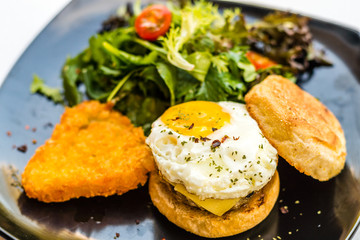 Handmade pork sausage  patty, egg, cheddar, Japanese wheat flour and Taiwan longan blossom honey muffin, with mesclun and crispy chunky hash brown.