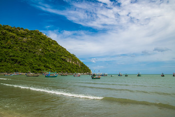 Thai traditional wooden longtail boat and beautiful sand beach 