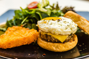 Handmade pork sausage  patty, egg, cheddar, Japanese wheat flour and Taiwan longan blossom honey muffin, with mesclun and crispy chunky hash brown.