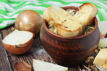 A ceramic pot with French onion soup