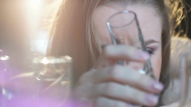 Female losing consciousness on bar counter after vodka shots, binge drinking