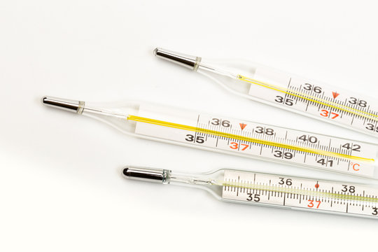 mercury thermometers on white background close up view