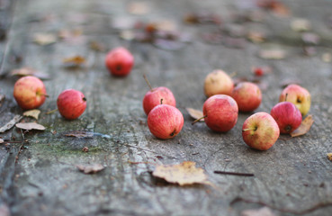 red apples lie on an old wooden table