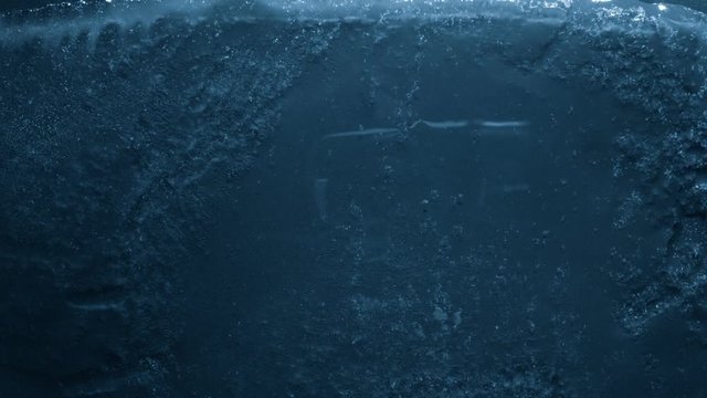 Close-up of melting ice on black background