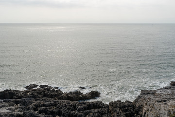 The coastline around gower, Wales with the waves conming into land