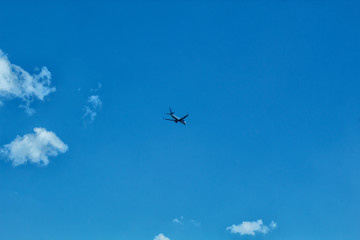 Fototapeta na wymiar The plane flies in the sky with clouds.
