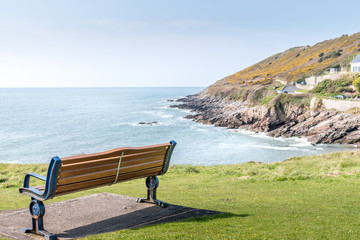 Naklejka na ściany i meble Empty bench on the mumbles coastline, Wales