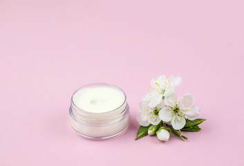 Fototapeta na wymiar Skincare product for face with spring flowers.