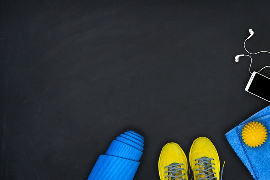 Fitness equipment on a black background. Concept of healthy lifestyle, sport and activity. Flat lay composition.