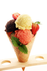 Set of ice cream scoops of different colors and flavours with berries and fruits