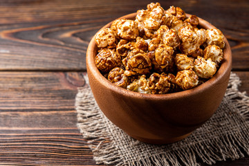 Popcorn on dark wooden background.