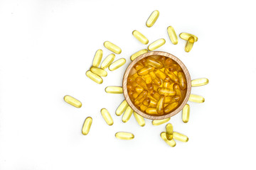 Close up top view of Gold fish oil in bowl isolated for good health on white background. Supplementary food. Omega 3. Vitamin E. Capsules salmon fish oil.