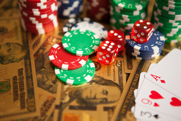 Casino red dices and casino poker chips on golden US Dollar bills © hamara