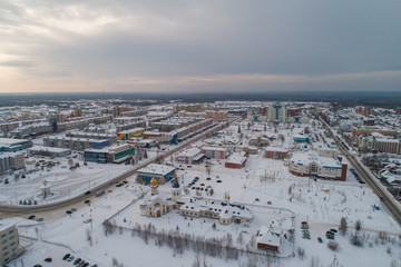 Church in Yugorsk city. Aerial. Winter, snow, cloudy. Khanty Mansiysk Autonomous Okrug (HMAO), Russia.