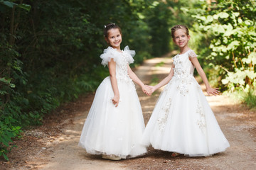 Obraz na płótnie Canvas happy beautiful girls with white wedding dresses