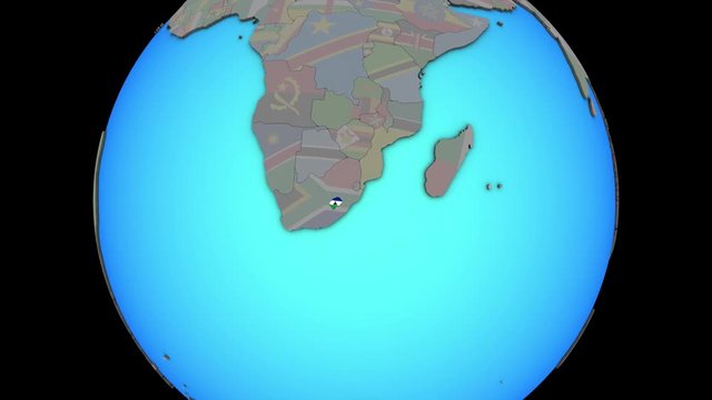 Closing in on Lesotho with embedded national flag on blue political 3D globe. 3D illustration.