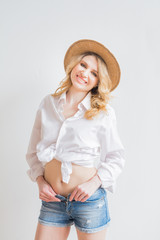 Beautiful Woman in a White Tee Shirt and denim shorts on white background