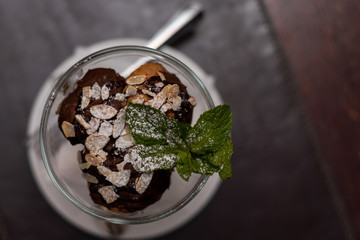 Delicious profiteroles desser sprinkled with nuts and powdered sugar. Close-up.