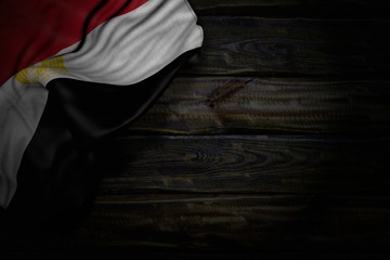 pretty holiday flag 3d illustration. - dark photo of Egypt flag with big folds on old wood with free place for your text