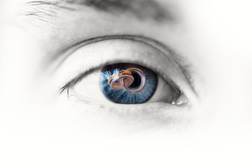 beautiful blue eye close up with two silver rings inside the eye