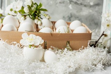 Easter still life. Gentle bright photo of egg and cherry blossoms.