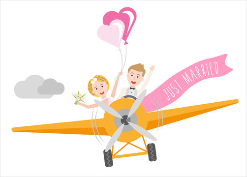 young couple just married sitting in an airplane