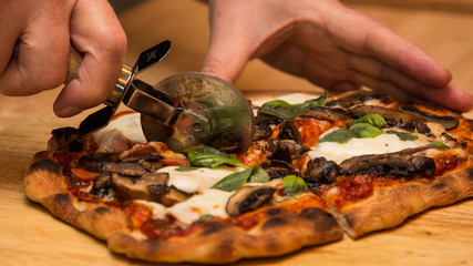 Closeup slicing homemade pizza