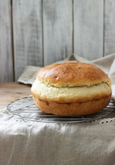 Fresh homemade wheat yeast bread on a linen tablecloth. Rustic style.