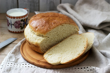 Fresh homemade wheat yeast bread on a linen tablecloth. Rustic style.