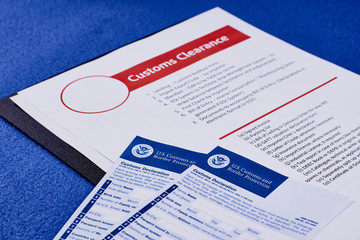 Page with the rules of customs clearance next to forms of the customs declaration - obrazy, fototapety, plakaty
