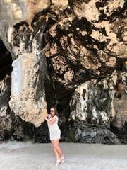 light-skinned girl in beach clothes on the background of hanging unique rocks of the island of Thailand on a clear day
