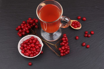viburnum with juice, jam, tea on black background 