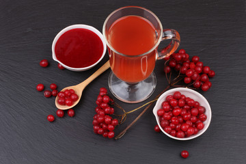 viburnum with juice, jam, tea on black background 
