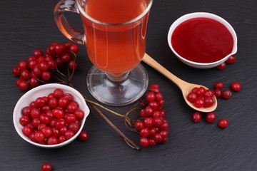 viburnum with juice, jam, tea on black background 