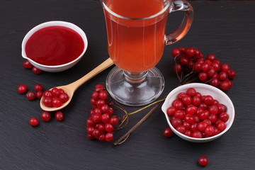 viburnum with juice, jam, tea on black background 