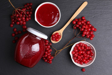 viburnum with juice, jam, tea on black background 