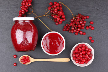 viburnum with juice, jam, tea on black background 