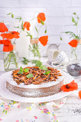 Pie with poppy seeds on a white background. Homemade pastries and red flowers.