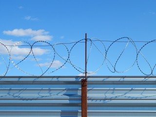 Fence with barbed wire to protect the territory. Closed perimeter