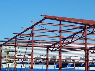 Fototapeta na wymiar Metal frame enterprise. Unfinished construction of the building.