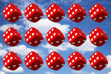 Close up of many playing dice, rotating on sky background.