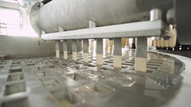 ice cream production, process of pouring ice cream and glaze in the form, production line, dairy products.