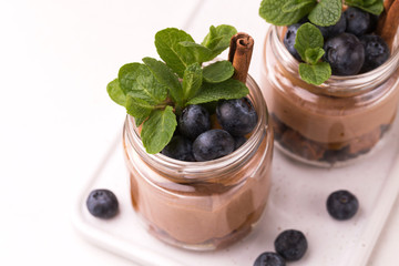 Cake dessert. Chocolate mousse with blueberry, mint and cinnamon